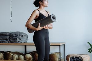Person holding a strong yoga warrior pose.