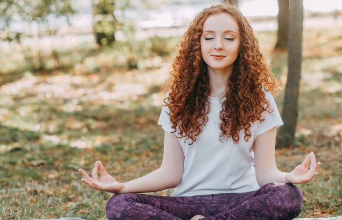 Person meditating in a serene setting, finding inner peace.
