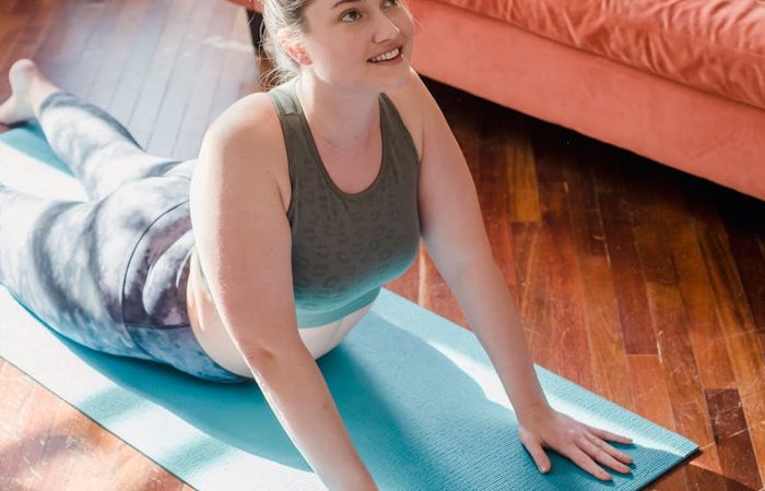 Person striking an energetic yoga pose, radiating vitality.